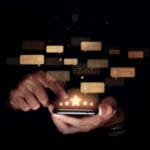 Consumer reviews concept, Hand of man using smartphone with five star for evaluate product and service.