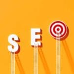 White ladders leaning on SEO written bull's eye target on yellow wall. Horizontal composition with copy space. SEO concept.