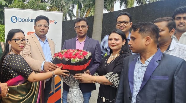 BookingMaster team presenting a bouquet to founders during 5th Annual Day celebration at JW Marriott